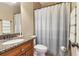 The bathroom features a granite countertop, tiled floors and a decorative shower curtain at 930 Custer St, Atlanta, GA 30354