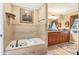Spacious bathroom featuring a soaking tub, tiled walls, and a large vanity at 930 Custer St, Atlanta, GA 30354
