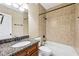Full bathroom with granite counter, tiled shower and bathtub with a tiled wall at 930 Custer St, Atlanta, GA 30354