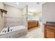 Bright bathroom with a soaking tub, tile surround and granite countertops at 930 Custer St, Atlanta, GA 30354