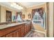 The bathroom features dual vanities, a large mirror, and decorative window treatments at 930 Custer St, Atlanta, GA 30354