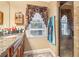 The bathroom features dual vanities, a window and a glass shower at 930 Custer St, Atlanta, GA 30354
