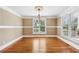 Bright dining room featuring hardwood floors and plenty of sunlight from the large windows at 930 Custer St, Atlanta, GA 30354