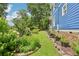 A side view of the house with a lush garden and walking path at 930 Custer St, Atlanta, GA 30354