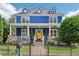 Charming blue two-story home with a welcoming front porch and a bright yellow front door at 930 Custer St, Atlanta, GA 30354