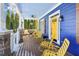 Inviting front porch with rocking chairs, ceiling fan, and blue exterior at 930 Custer St, Atlanta, GA 30354