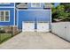 Two car detached garage with white doors and black hardware at 930 Custer St, Atlanta, GA 30354