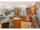 Beautiful kitchen with stainless appliances, custom wood cabinetry, breakfast bar with stone accent, and granite countertops at 930 Custer St, Atlanta, GA 30354