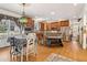 Open concept eat-in kitchen with stainless appliances, a breakfast bar with stone accents, and wood floors at 930 Custer St, Atlanta, GA 30354