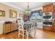 Spacious eat-in kitchen featuring custom cabinets, double ovens, a large window, and hardwood floors at 930 Custer St, Atlanta, GA 30354