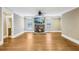 Bright living room featuring a stone fireplace, TV, and hardwood floors at 930 Custer St, Atlanta, GA 30354