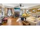 Inviting living room with a stone fireplace, hardwood floors, abundant natural light, and ample seating at 930 Custer St, Atlanta, GA 30354