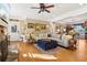 Bright living room featuring a stone fireplace, hardwood floors, and a large comfortable sectional sofa at 930 Custer St, Atlanta, GA 30354