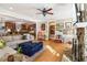 Open-concept living room flowing to kitchen featuring a stone fireplace, hardwood floors, and comfortable seating at 930 Custer St, Atlanta, GA 30354