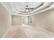 Spacious main bedroom with tray ceiling, ceiling fan, and neutral carpet at 930 Custer St, Atlanta, GA 30354