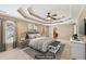 Virtually staged main bedroom featuring a ceiling fan, tray ceiling, and neutral decor at 930 Custer St, Atlanta, GA 30354