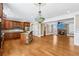 Inviting open-concept kitchen, dining and living area with wood floors and fireplace at 930 Custer St, Atlanta, GA 30354