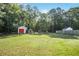 Well-maintained backyard featuring a shed and a greenhouse, perfect for gardening and outdoor storage at 320 Windermere Dr, Loganville, GA 30052