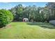 Spacious backyard featuring lush greenery and a charming shed, ideal for outdoor activities and relaxation at 320 Windermere Dr, Loganville, GA 30052