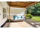 Backyard patio with porch swing shows the perfect place to relax outdoors at 320 Windermere Dr, Loganville, GA 30052