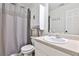 Clean bathroom featuring white cabinetry, a neutral shower curtain, and essential bathroom fixtures at 320 Windermere Dr, Loganville, GA 30052