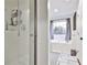 Clean bathroom featuring a glass shower and separate soaking tub near a window at 320 Windermere Dr, Loganville, GA 30052