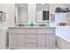 Bathroom featuring a double vanity with granite counters and modern fixtures at 320 Windermere Dr, Loganville, GA 30052