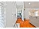 Bright entryway features hardwood flooring, white trim, and views into the kitchen at 320 Windermere Dr, Loganville, GA 30052