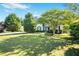 Charming home showcasing a well-manicured lawn and inviting curb appeal with mature trees at 320 Windermere Dr, Loganville, GA 30052