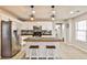 Bright kitchen featuring island, stainless steel appliances, and modern pendant lighting at 320 Windermere Dr, Loganville, GA 30052
