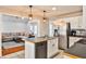 Open kitchen features stainless steel appliances, center island, and easy access to living room at 320 Windermere Dr, Loganville, GA 30052