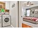 Convenient laundry room adjacent to a main bedroom, featuring modern appliances at 320 Windermere Dr, Loganville, GA 30052