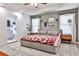 Spacious main bedroom with tray ceiling, decorative rug, and ensuite bath access at 320 Windermere Dr, Loganville, GA 30052