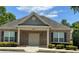 Brick community clubhouse with a tan door and landscaping at 5680 Cascade Sw Run, Atlanta, GA 30336