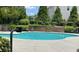 Kidney-shaped community pool with plenty of lounge chairs at 5680 Cascade Sw Run, Atlanta, GA 30336
