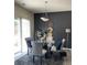Charming dining area with glass table and modern lighting at 5680 Cascade Sw Run, Atlanta, GA 30336
