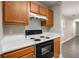 View of kitchen stove, oven, and overhead cabinets at 7024 Branch Crossing Way, Douglasville, GA 30134