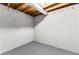 Unfinished basement corner with white block walls and grey floor at 4145 White Oak Dr, Winston, GA 30187