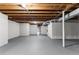 Unfinished basement with exposed beams, white block walls, and a grey floor at 4145 White Oak Dr, Winston, GA 30187