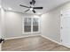 Spacious bedroom with wood-look floors, ceiling fan, and large windows at 4145 White Oak Dr, Winston, GA 30187