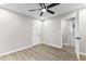 Bright bedroom featuring wood-look floors, ceiling fan, and access to bathroom at 4145 White Oak Dr, Winston, GA 30187