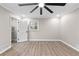 Well-lit bedroom with wood-look floors, ceiling fan and walk-in closet at 4145 White Oak Dr, Winston, GA 30187