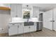 Modern kitchen features white cabinets, quartz countertops, and a farmhouse sink at 4145 White Oak Dr, Winston, GA 30187