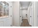 Bright laundry room with white door, wood-look flooring, and a window at 4145 White Oak Dr, Winston, GA 30187