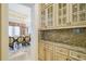 Butler's pantry with glass-front cabinetry and granite countertops at 4787 Northside Dr, Atlanta, GA 30327