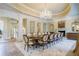 Formal dining room with large table, chandelier, and fireplace at 4787 Northside Dr, Atlanta, GA 30327