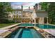 Luxury home with a large pool and spa, surrounded by lush landscaping at 4787 Northside Dr, Atlanta, GA 30327