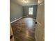 Bedroom featuring vinyl floors, neutral paint, a closet and a window letting in natural light at 54 Cross Branches, Acworth, GA 30101