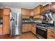 Close up on kitchen featuring stainless steel appliances and wooden cabinets at 54 Cross Branches, Acworth, GA 30101