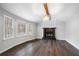 Bright living room featuring a fireplace, hardwood floors, and large windows at 54 Cross Branches, Acworth, GA 30101